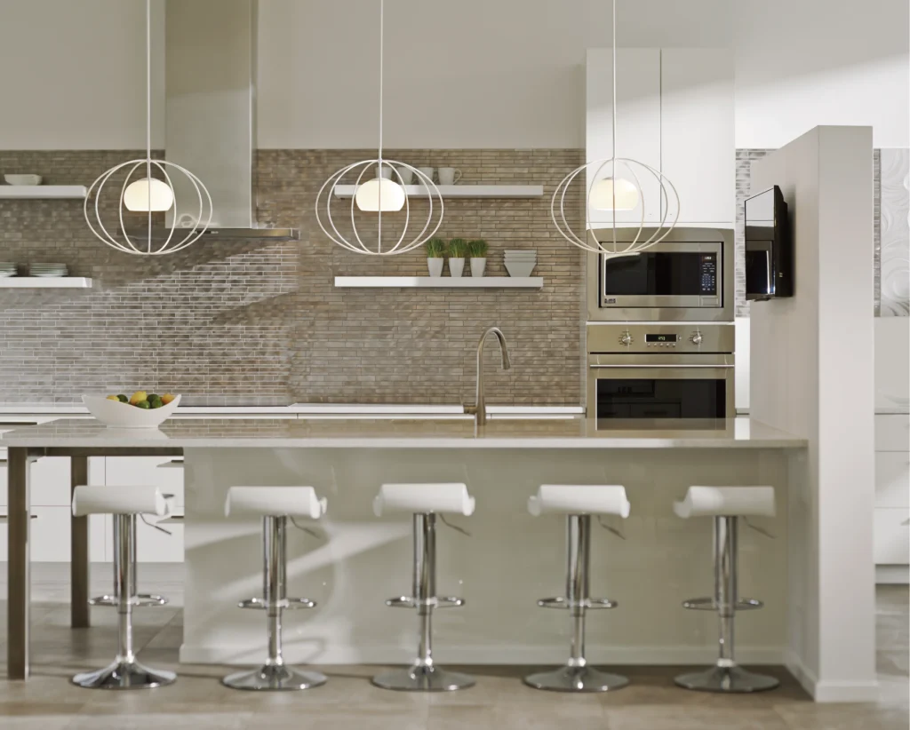 Modern kitchen with luxury custom cabinetry and European design in Southern California, featuring sleek white cabinets, stainless steel appliances, and contemporary pendant lighting over a stylish island with bar stools.