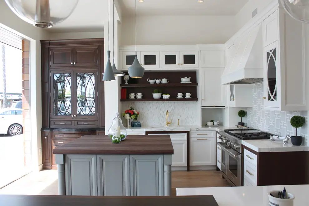 Modern kitchen with custom cabinetry featuring a blend of white and dark wood finishes, elegant storage solutions, and a central island with a wooden countertop. Stylish pendant lighting and stainless steel appliances enhance the contemporary design.