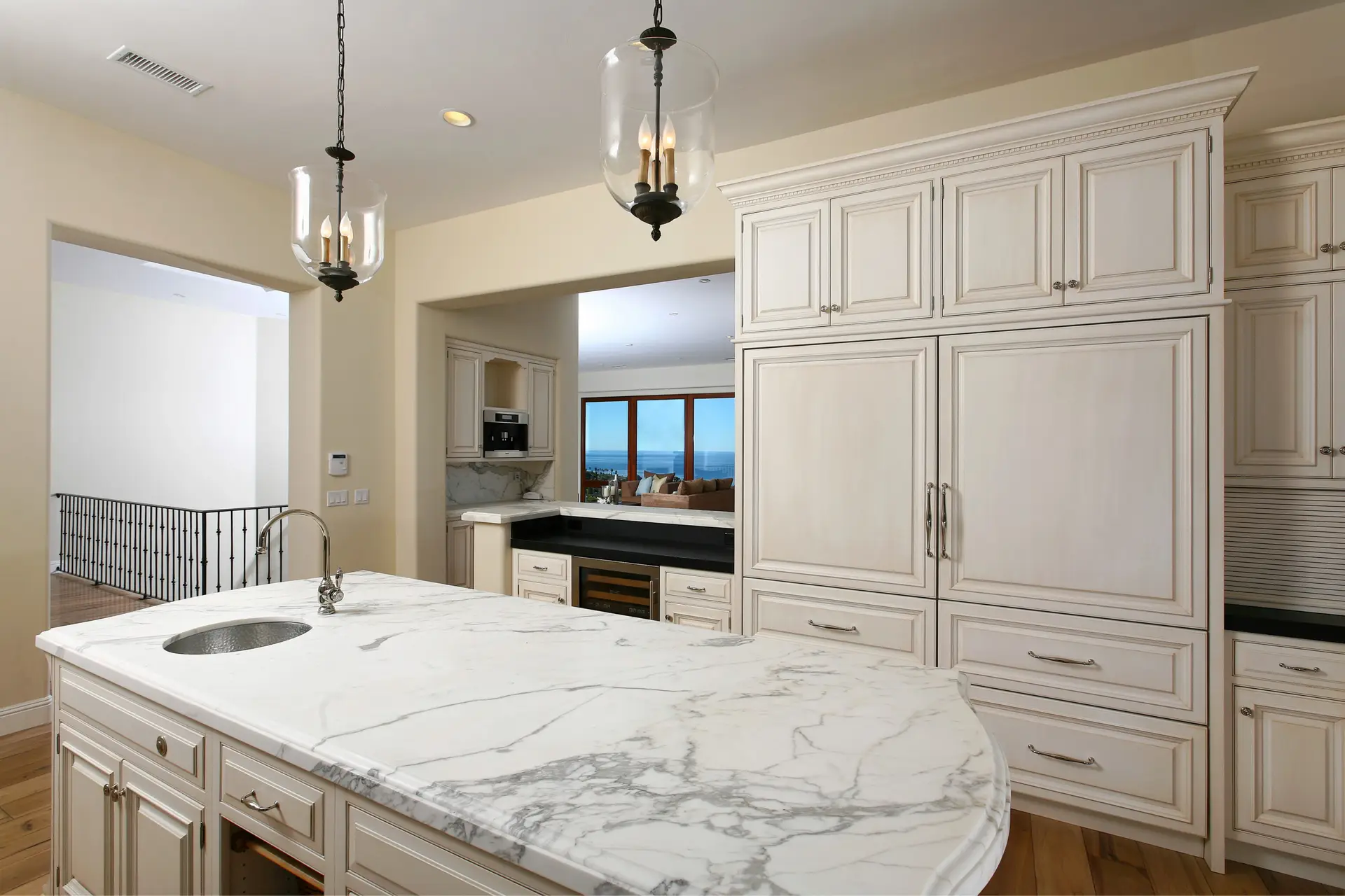 Luxury kitchen with custom cabinetry and marble countertop, featuring modern design and elegant l