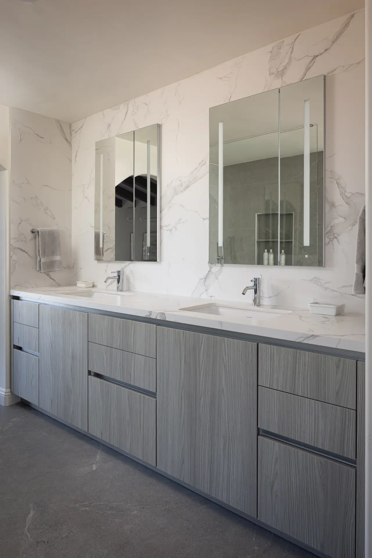 Custom double vanity bathroom cabinetry with marble backsplash and modern storage &mdash; Inplace Studio La Jolla San Diego