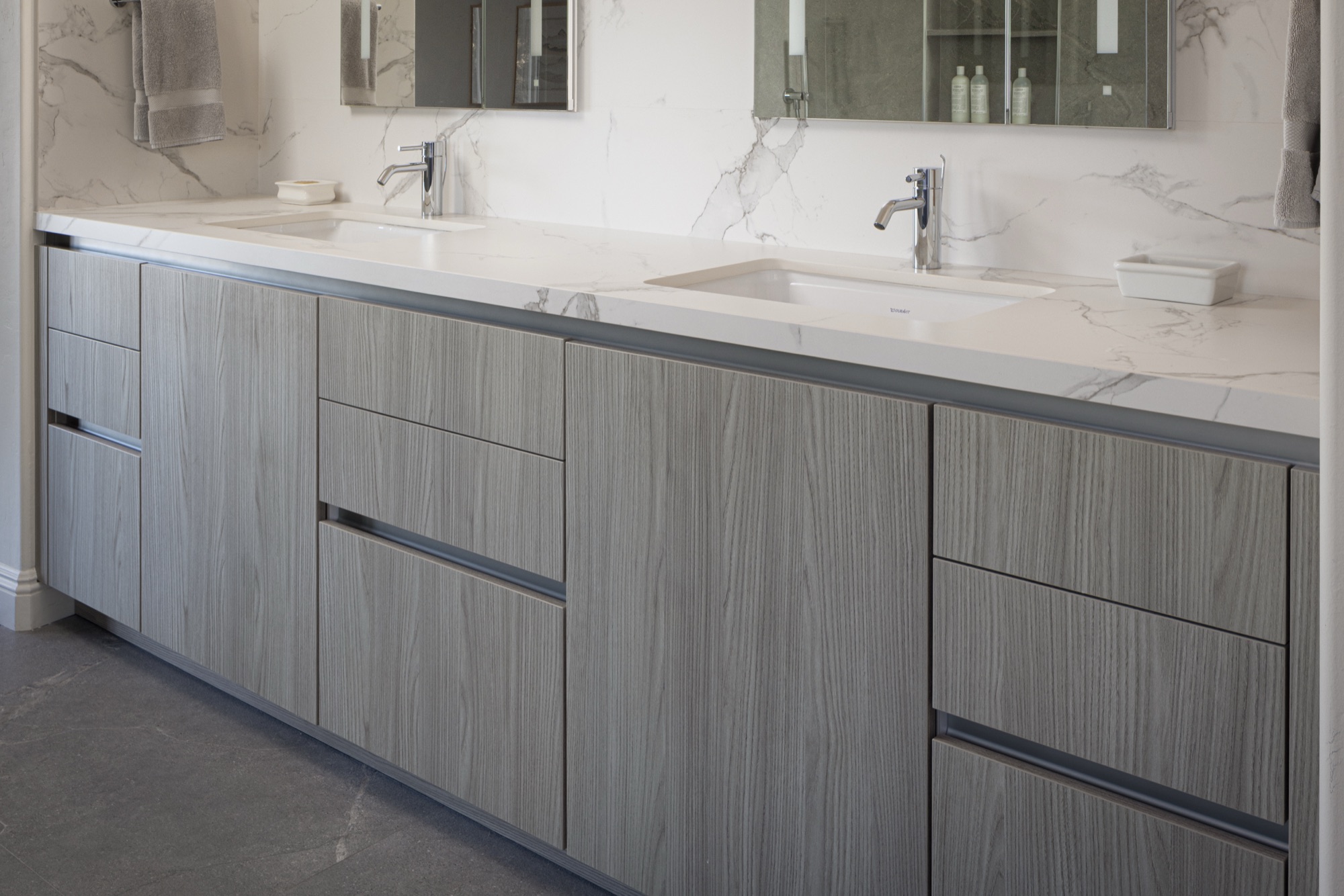 Handleless grey woodgrain vanity cabinetry detail, La Jolla bathroom by Inplace Studio