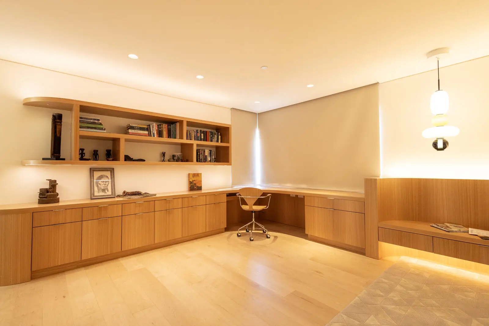 Custom eucalyptus veneer built-in office cabinetry and shelving — San Diego