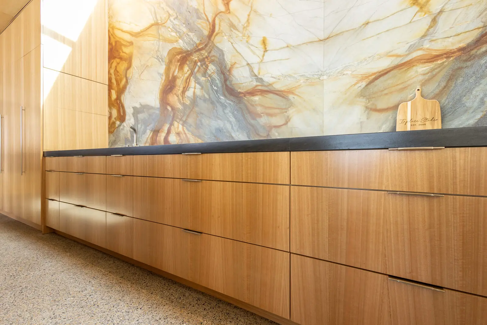 Eucalyptus veneer counter and cabinetry by the window — San Diego custom cabinetry