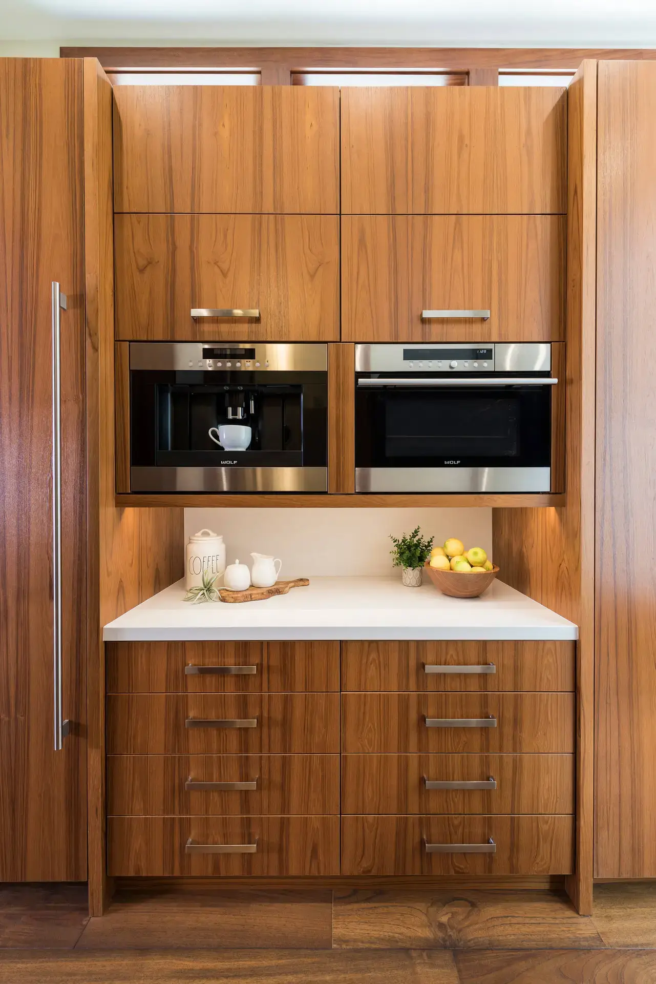 Luxurious custom kitchen cabinetry with modern wooden design featuring built-in appliances in high-end San Diego & LA homes.