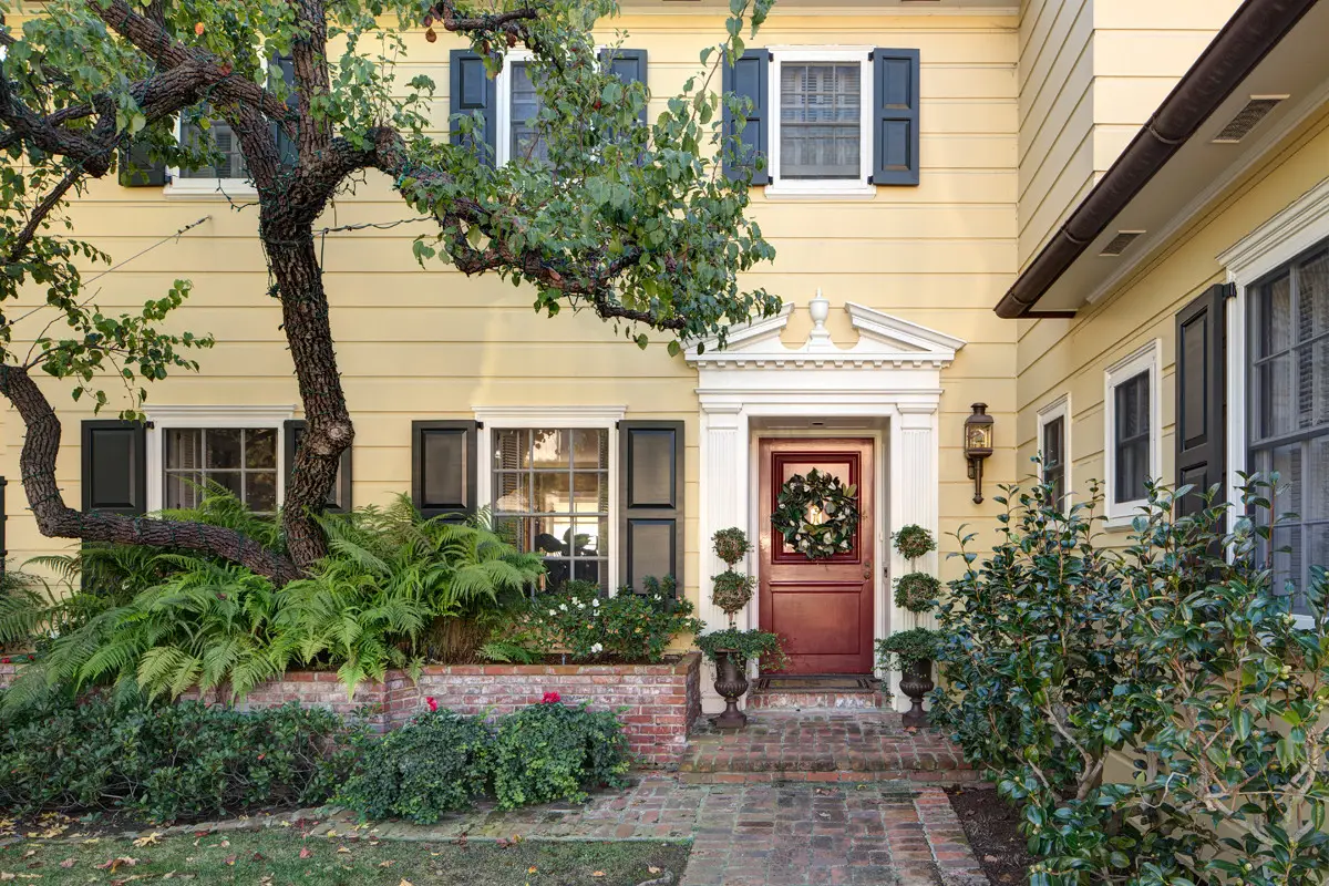 Yellow exterior of a traditional house with d