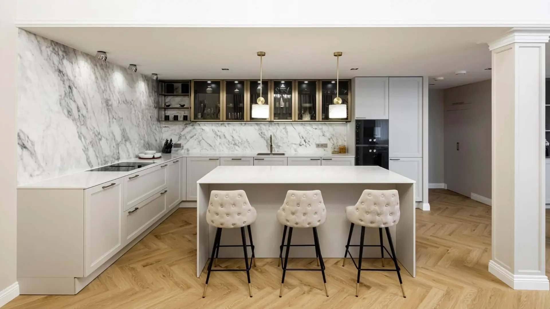 Classic kitchen island with marble backsplash and brass-framed glass uppers &mdash; SieMatic CLASSIC