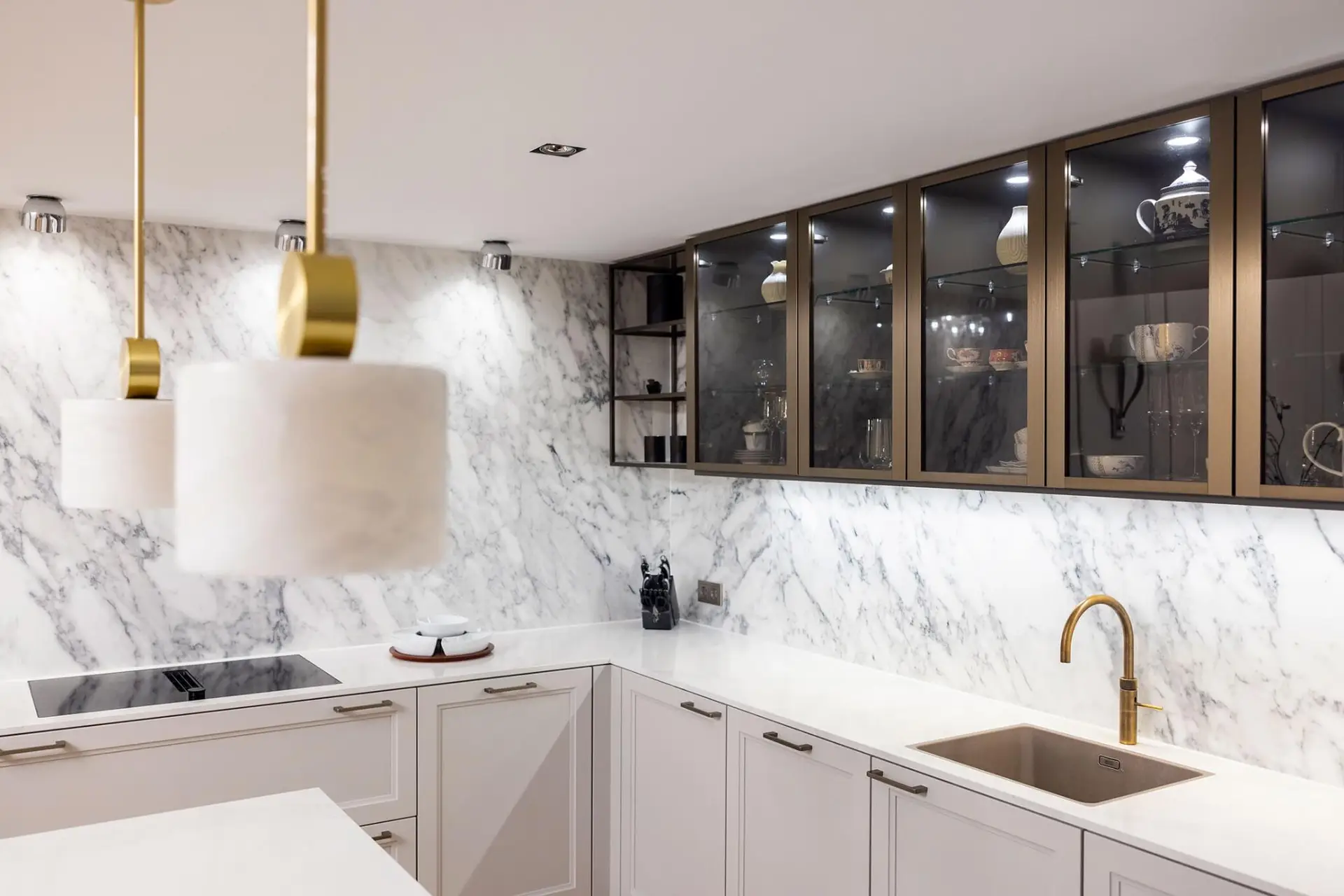Classic white framed kitchen with Calacatta marble walls and bronze glass cabinets &mdash; SieMatic CLASSIC