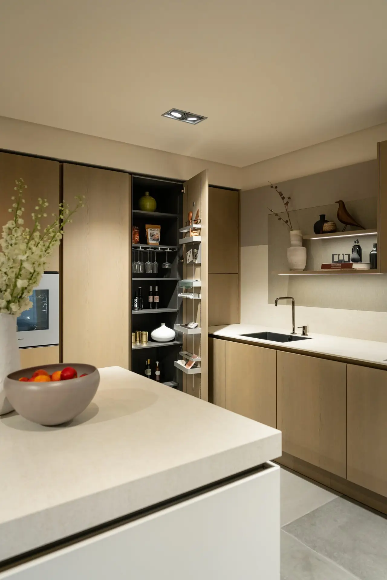 SieMatic Pure kitchen with open pantry tower and stone island