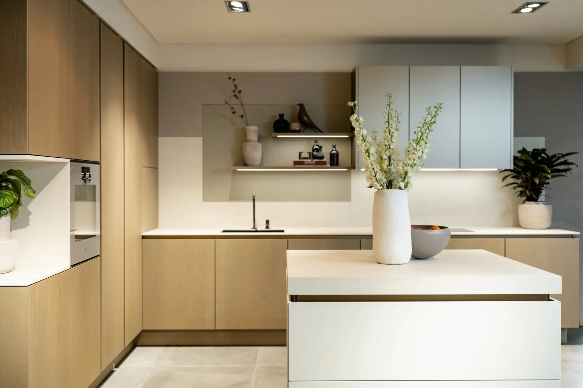 SieMatic SLX kitchen with grey wall cabinets and white handleless island