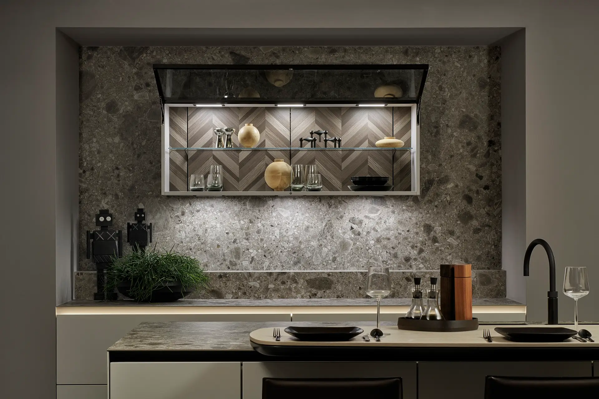 SieMatic SLX lift-door wall cabinet against a terrazzo stone wall