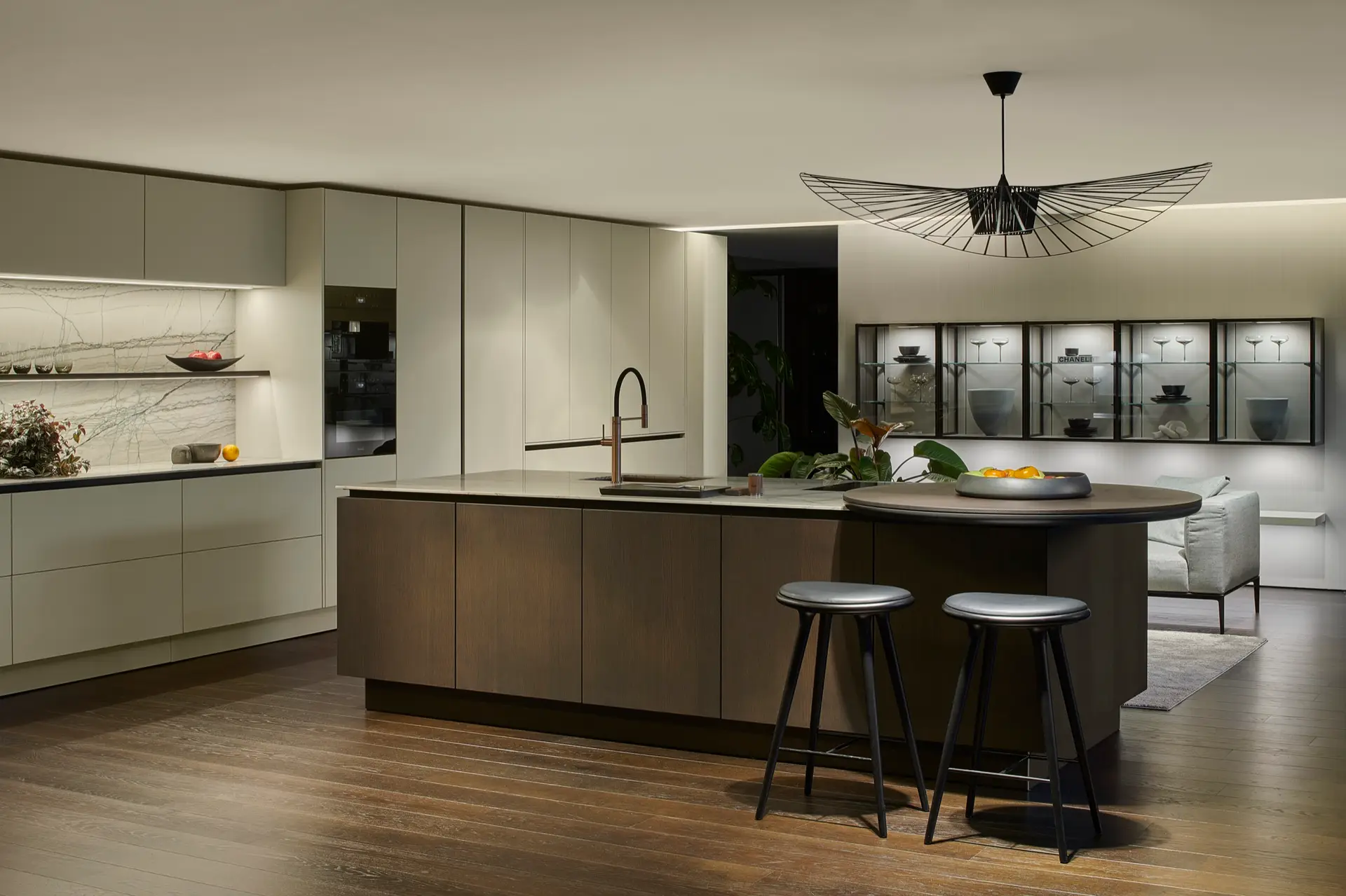 SieMatic SLX sage kitchen island with wall vitrines and pendant light