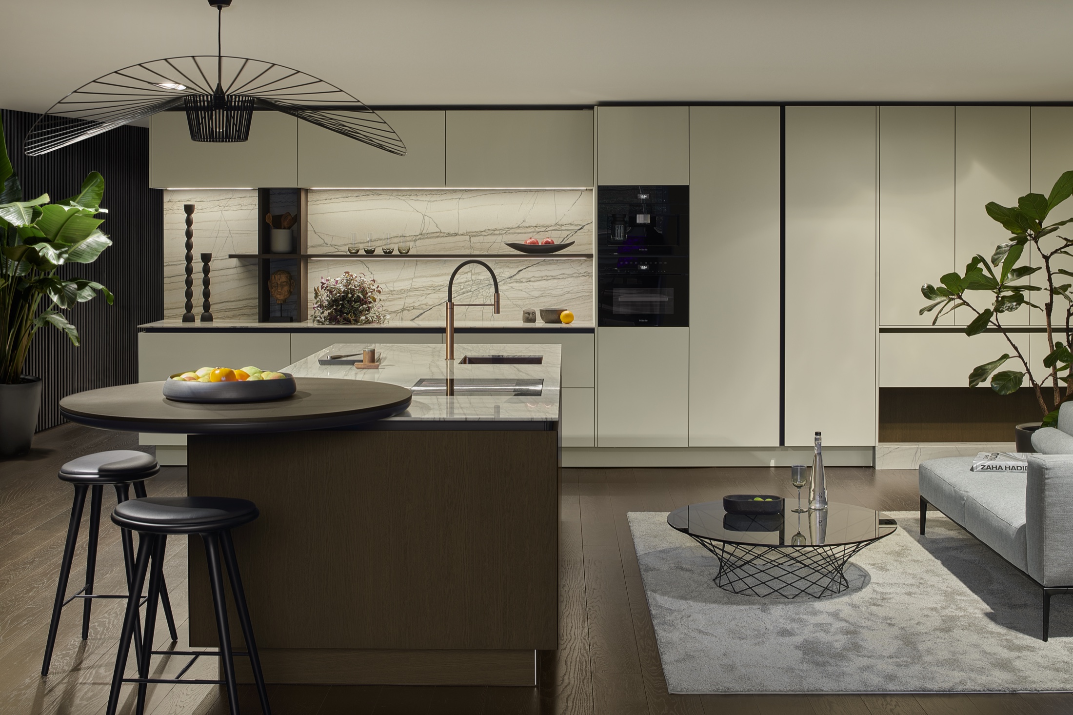 SieMatic SLX sage kitchen with round island and stone marble backsplash