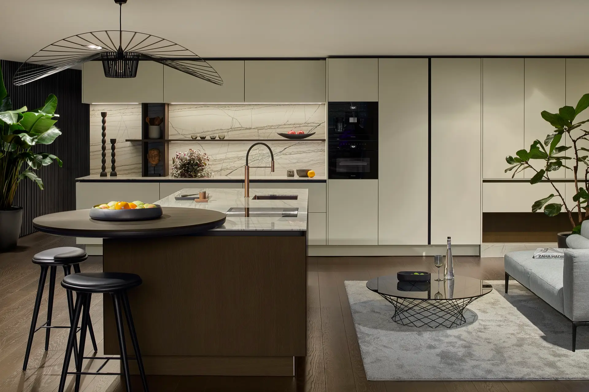SieMatic SLX sage kitchen with round island and stone marble backsplash