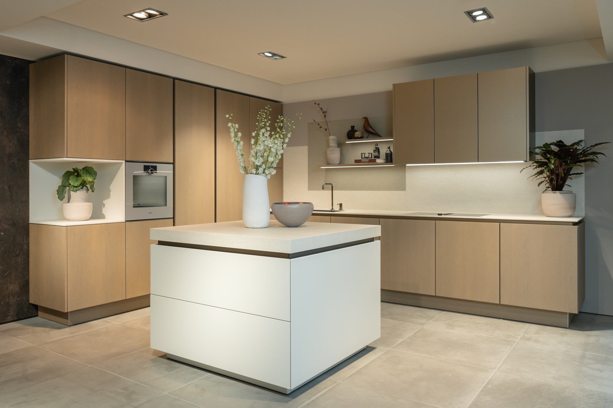 SieMatic SLX showroom kitchen with white monolith island and taupe cabinetry