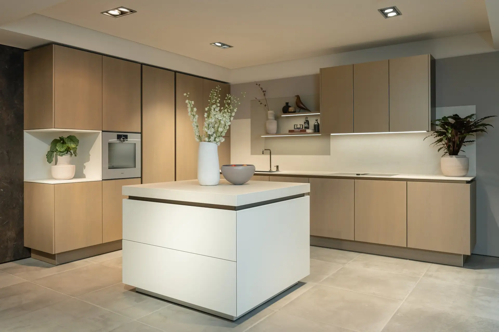 SieMatic SLX showroom kitchen with white monolith island and taupe cabinetry
