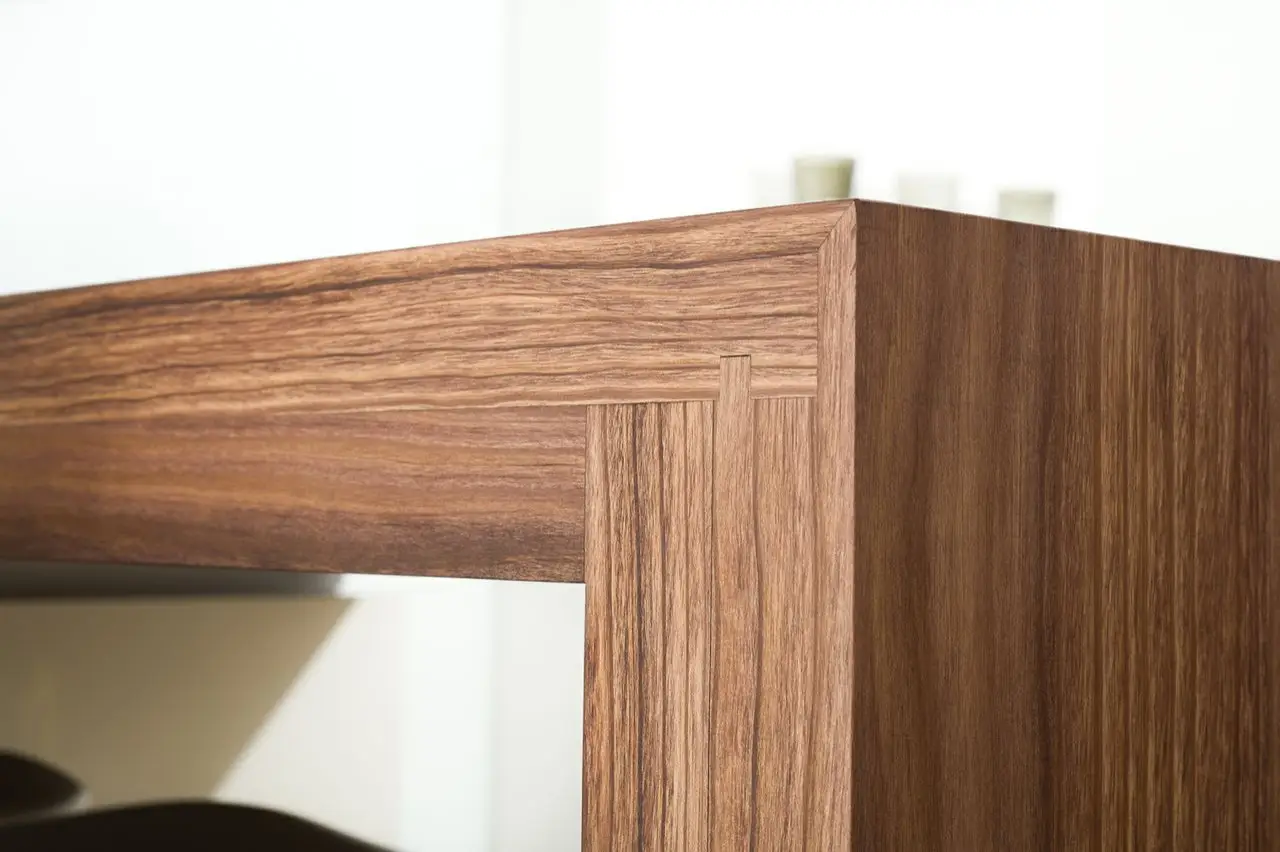 Close-up of luxury custom cabinetry with elegant wood grain finish, showcasing expert craftsmanship in closet design.