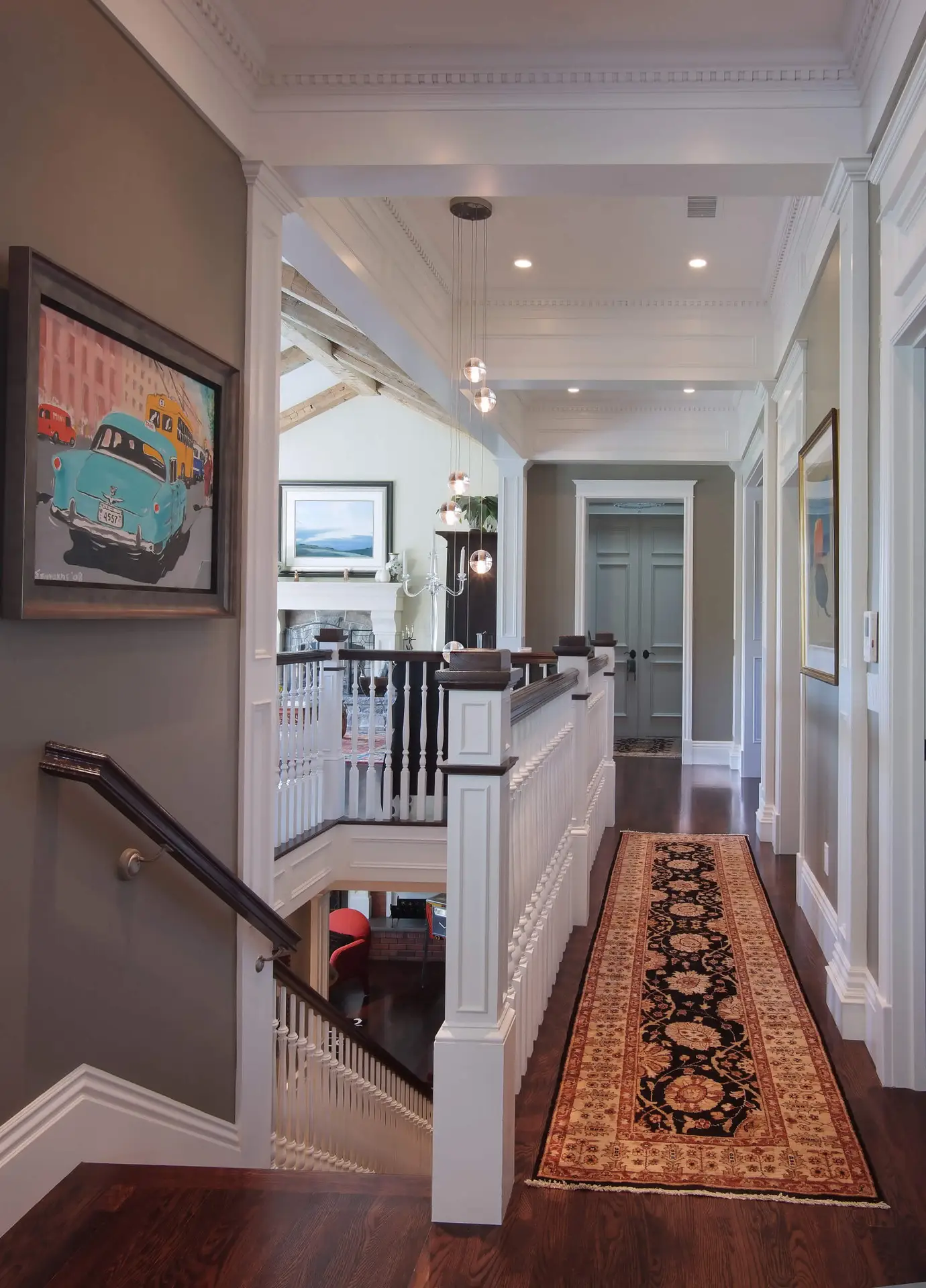 Elegant hallway in a vintage-style home remodel in SD. Features include a decorative rug, traditional wainscot