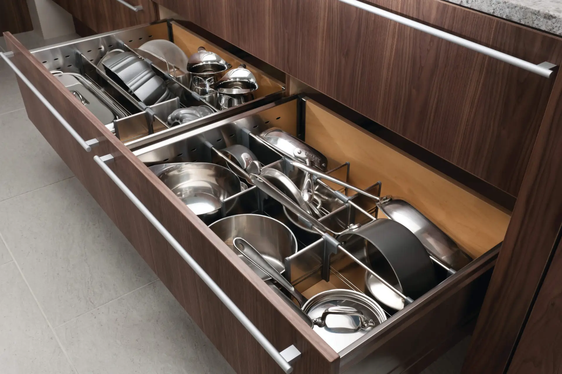 High-end European kitchen drawer with luxury custom cabinetry featuring organized stainless steel cookware.