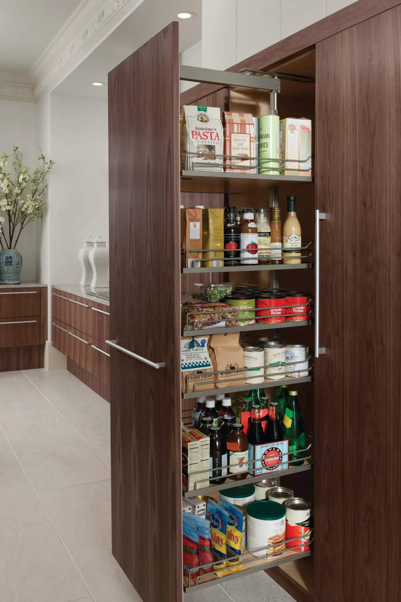 A luxury kitchen with elegant transitional cabinetry featuring a pull-out pantry organized