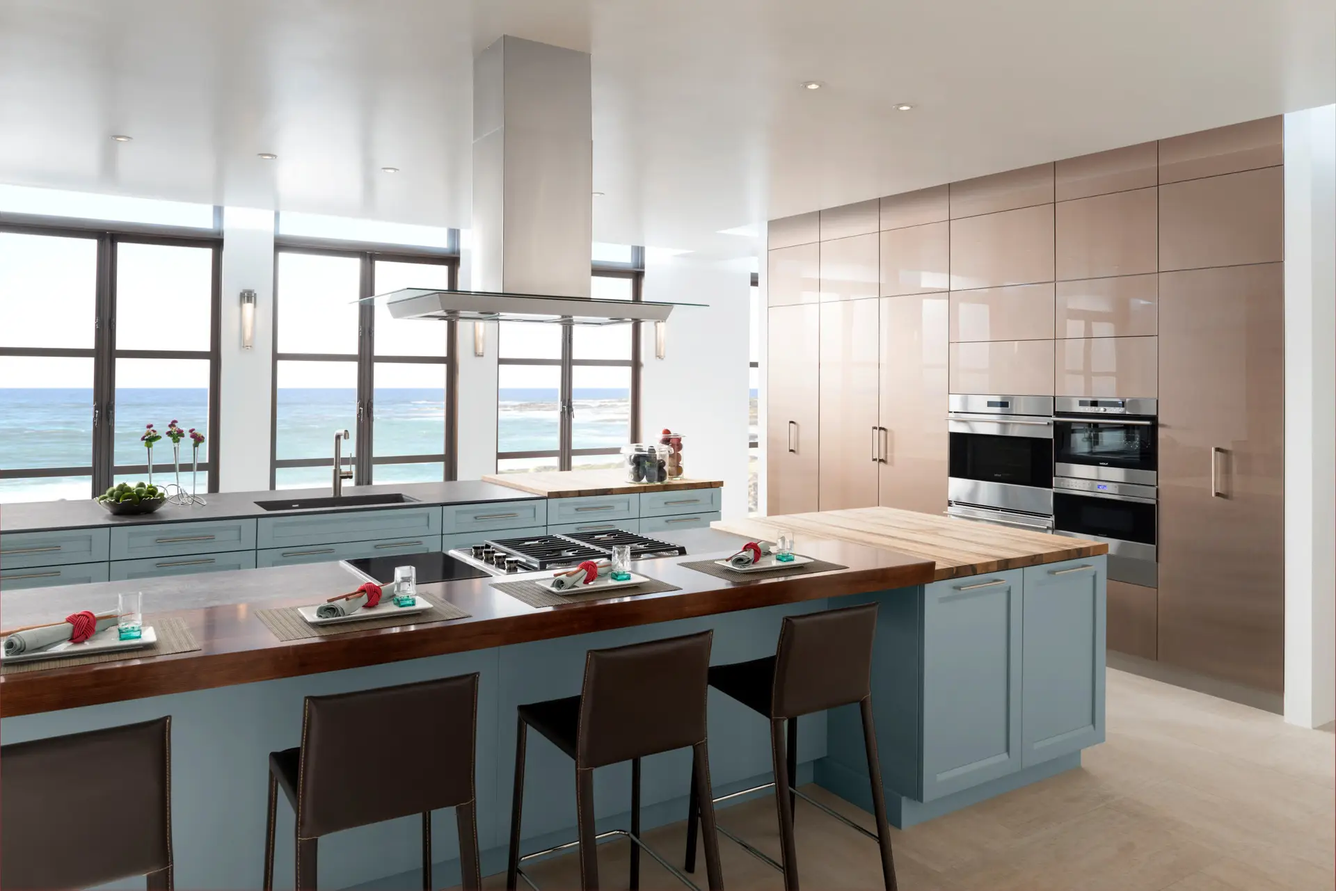 Modern kitchen with custom cabinetry, featuring sleek blue cabinets, stainless steel appliances