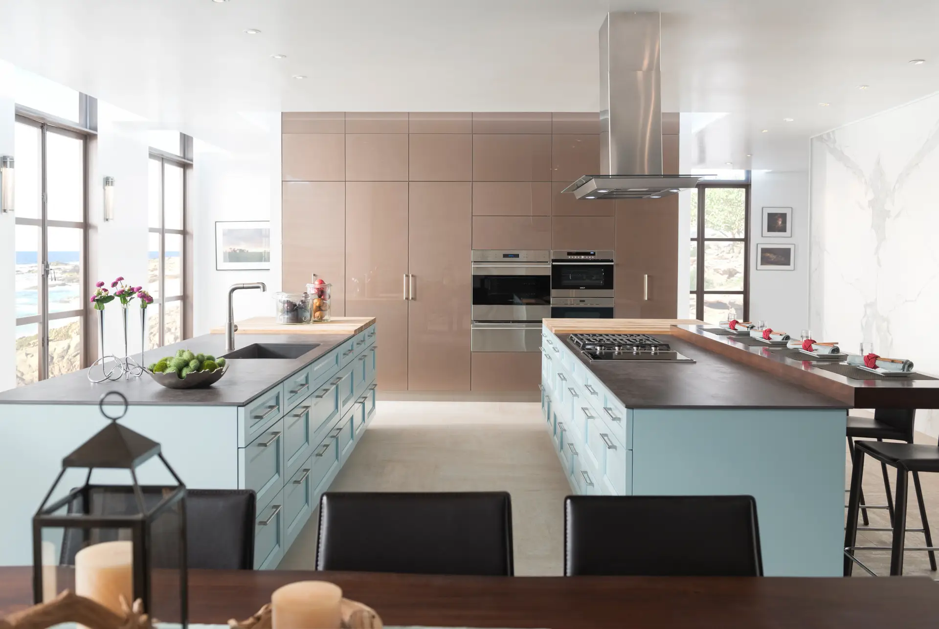 Elegant modern kitchen with custom cabinetry in San Diego, featuring sleek light blue storage cabinets and a spacious kitchen island with bar seating, providing ample counter space and a contemporary design aesthetic.