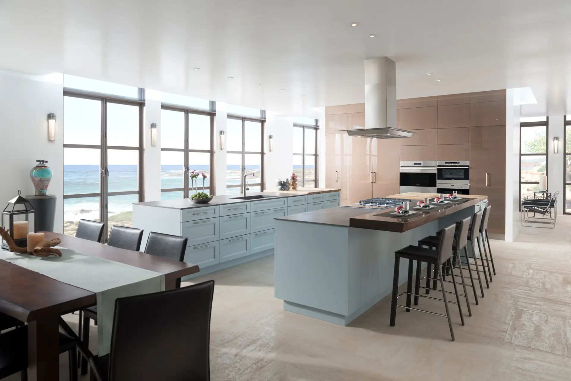 Modern kitchen with custom cabinetry in San Diego, featuring sleek blue cabinets, a large island with barstools, stainless steel appliances, and large windows overlooking the ocean.