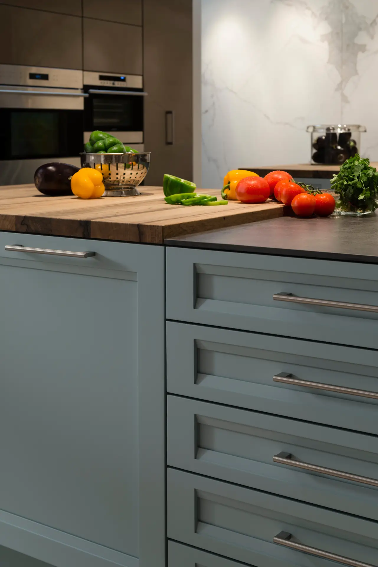 Modern kitchen with custom cabinetry featuring sleek drawers and a wooden countertop