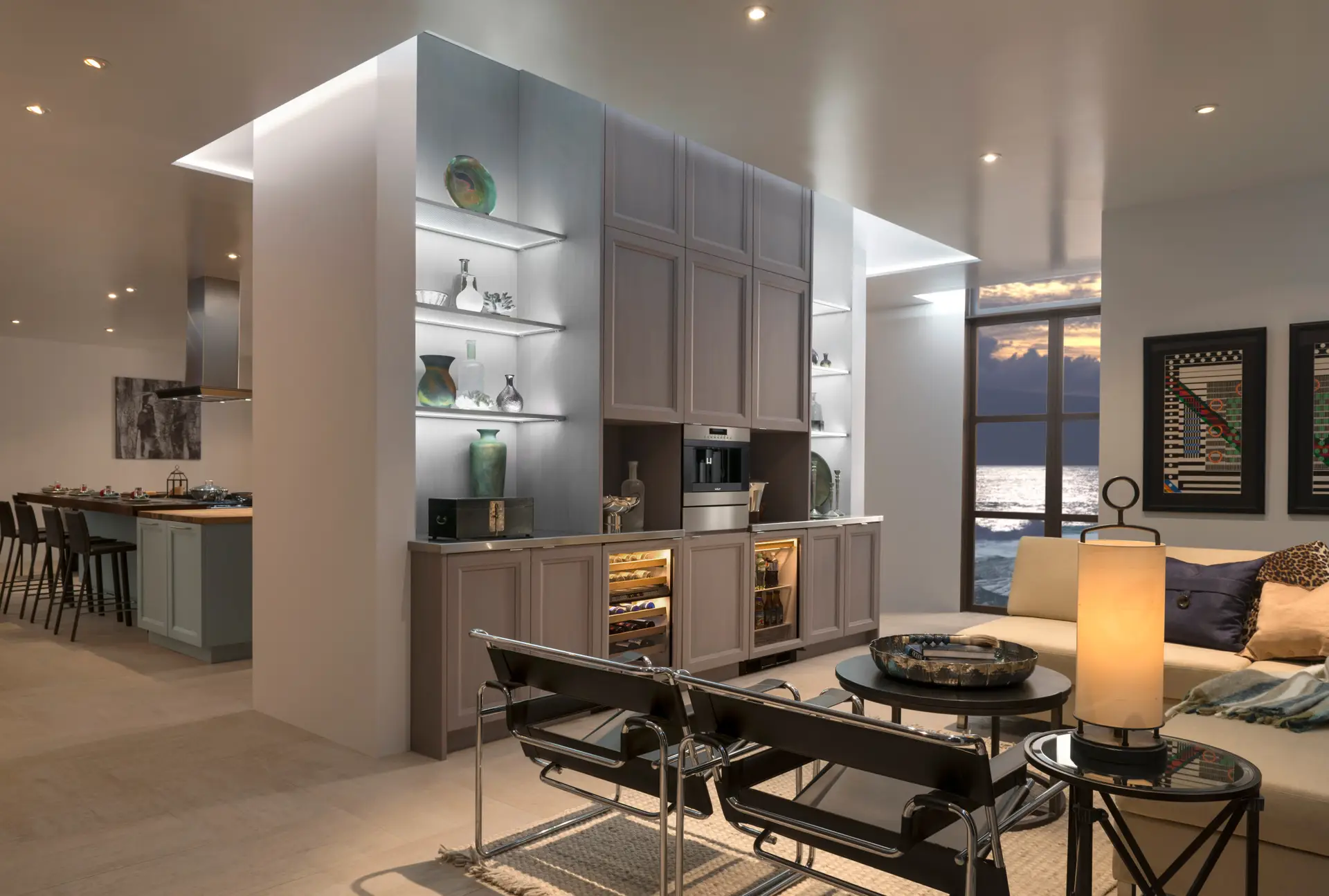 Luxurious open-concept living space with custom cabinetry featuring elegant display shelves and integrated wine storage, located in a modern San Diego home with ocean view.