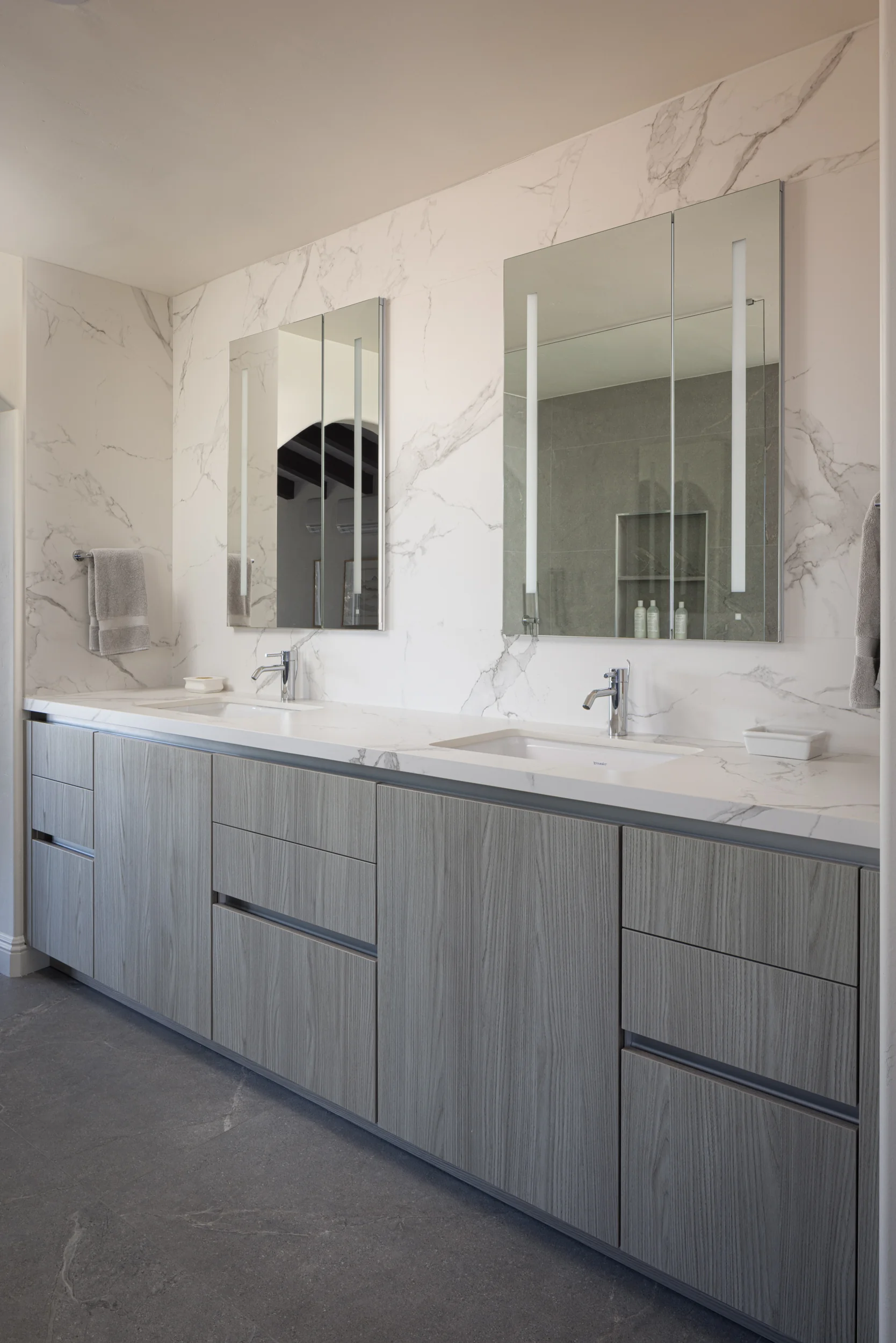 Custom double-vanity bathroom with marble backsplash - Inplace Studio La Jolla
