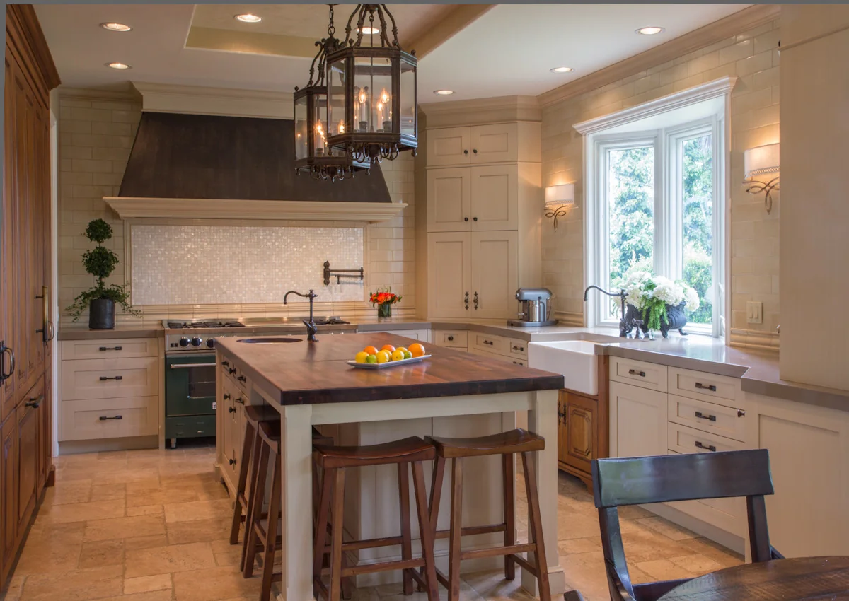 Luxurious kitchen in Los Angeles featuring elegant custom cabinetry, a large wooden island with stools, high-end appliances