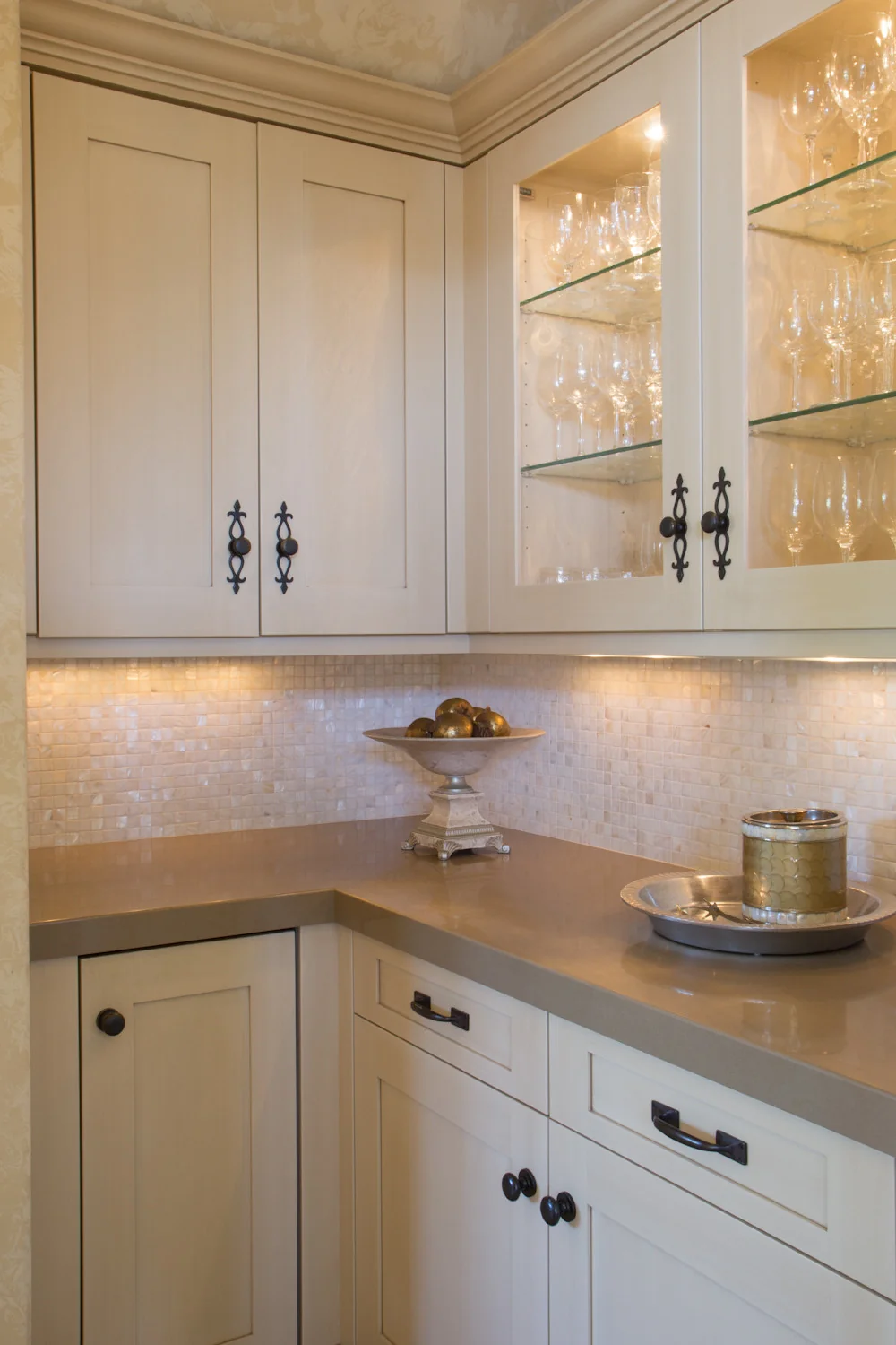 Elegant custom cabinetry in a Los Angeles home, featuring cream-colored cabinets with black iron handles