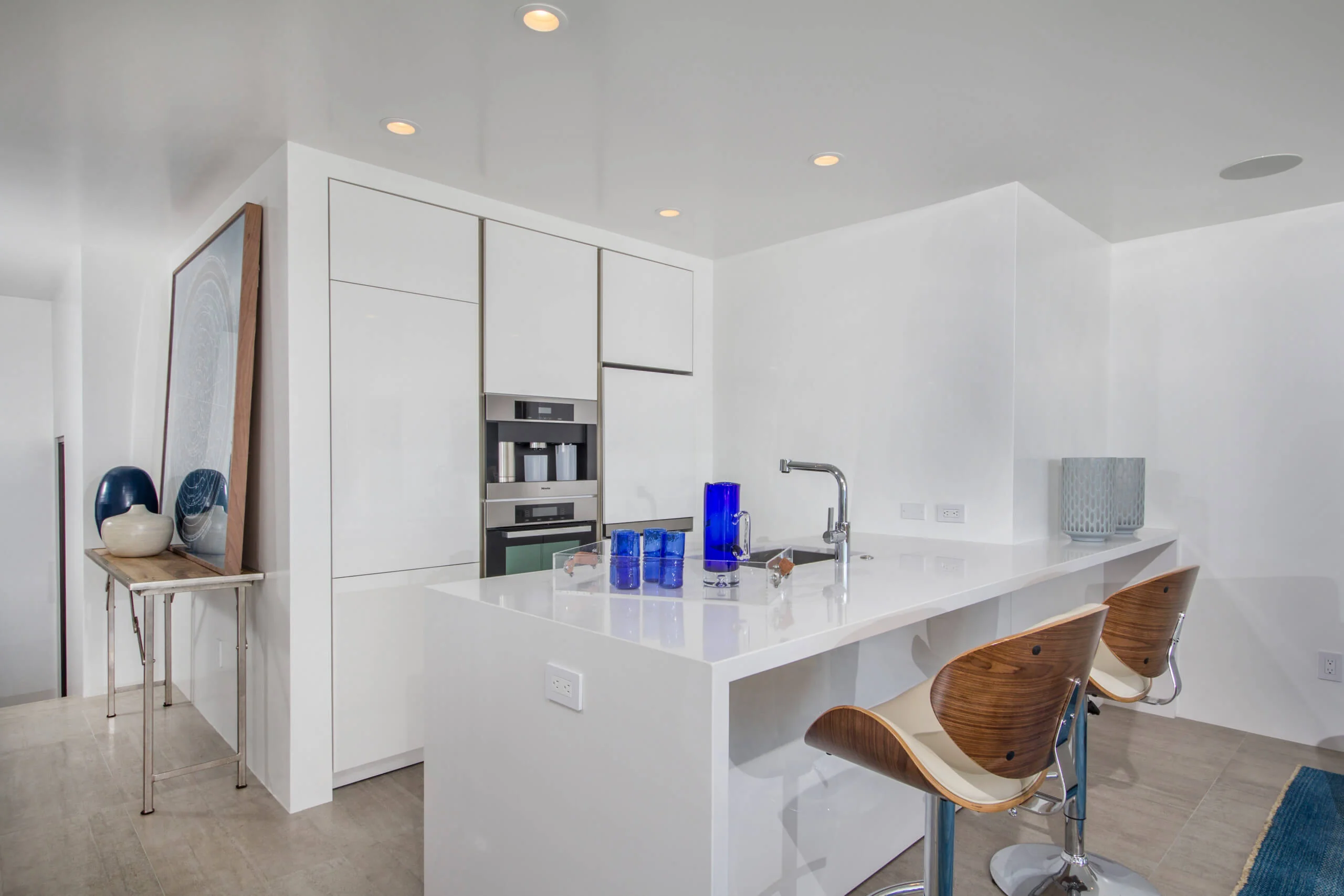 Modern kitchen with sleek white custom cabinets and a minimalist design in Encinitas