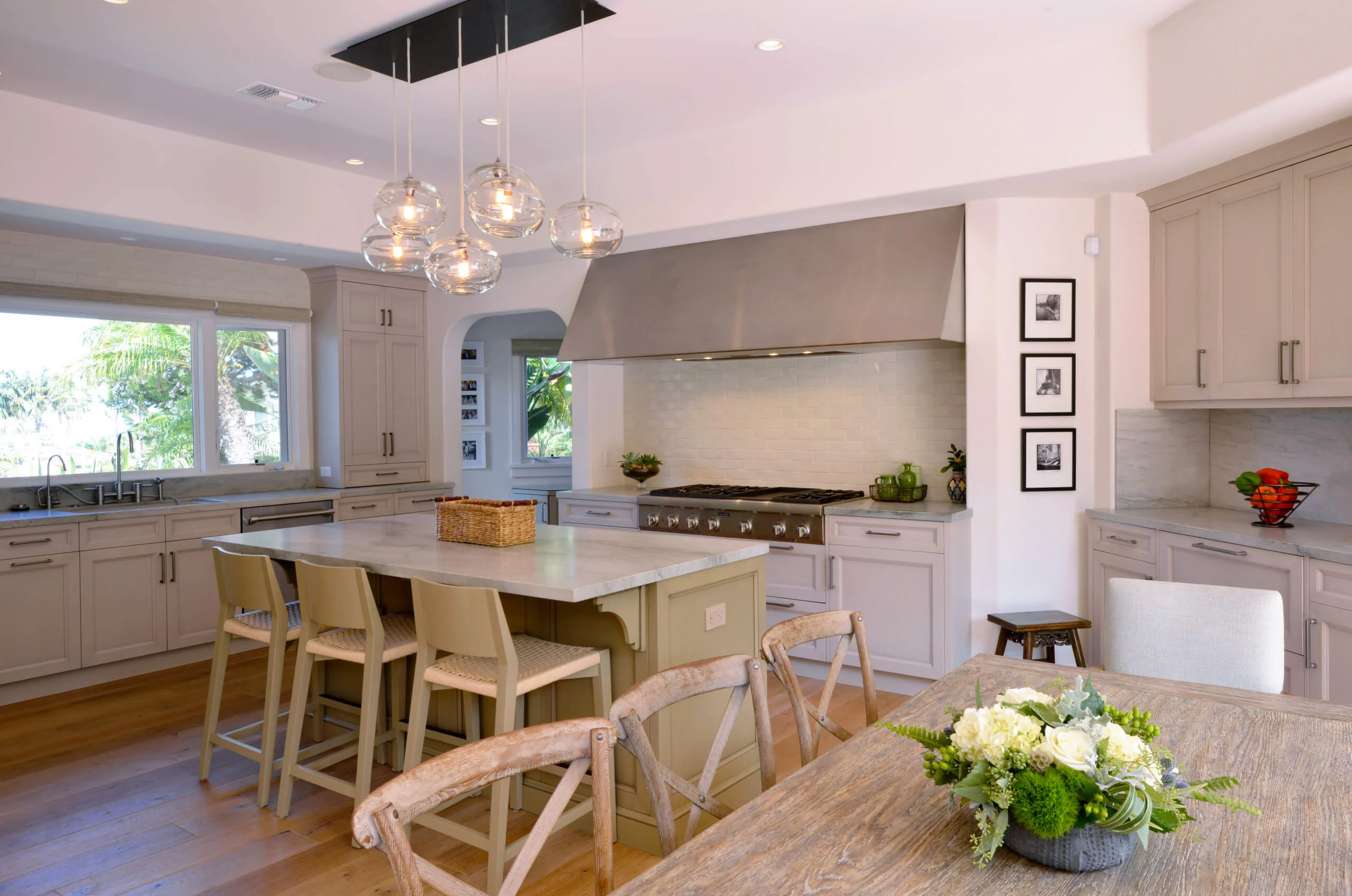 Modern kitchen with custom cabinets, marble island, and stylish lighting in a contemporary home