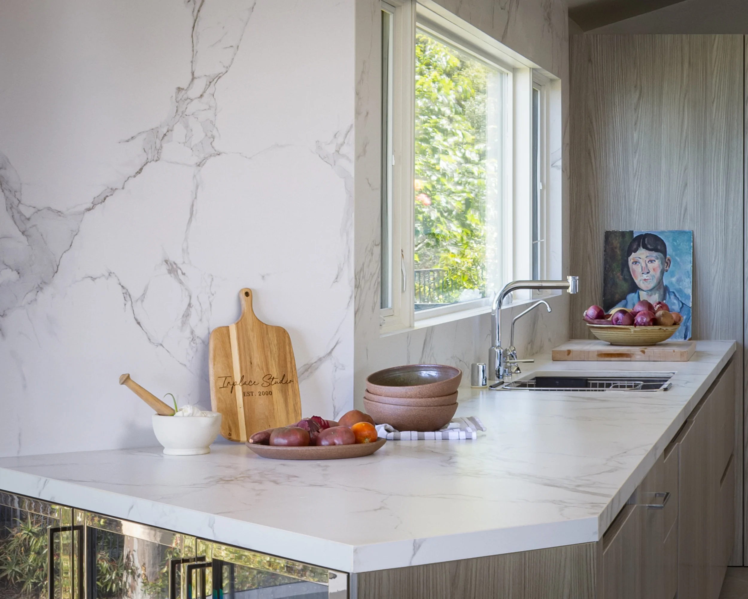 Dekton countertop and handleless woodgrain cabinetry detail in a high-end La Jolla kitchen