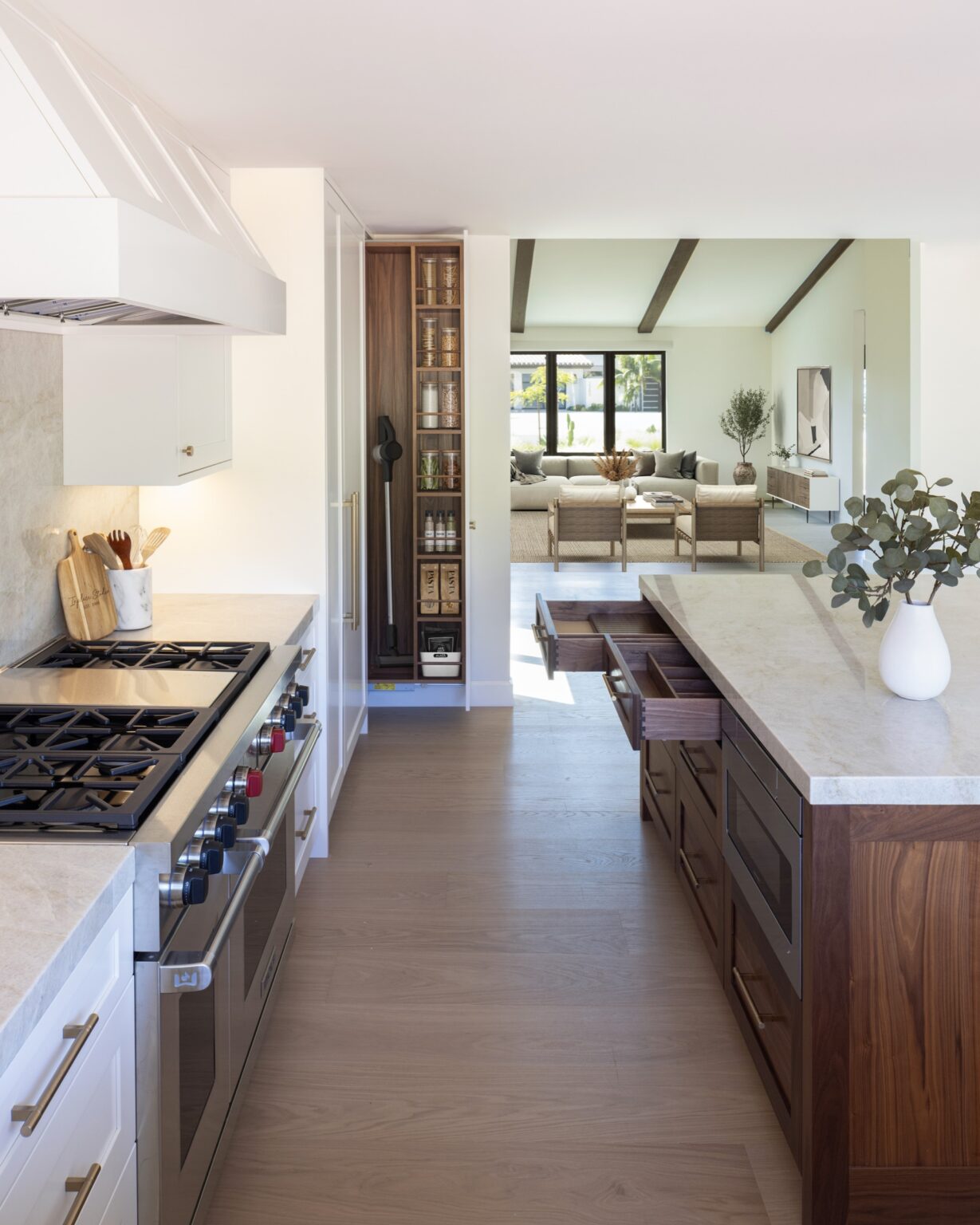 Open walnut dovetail drawers and microwave drawer in a Wood-Mode walnut kitchen island