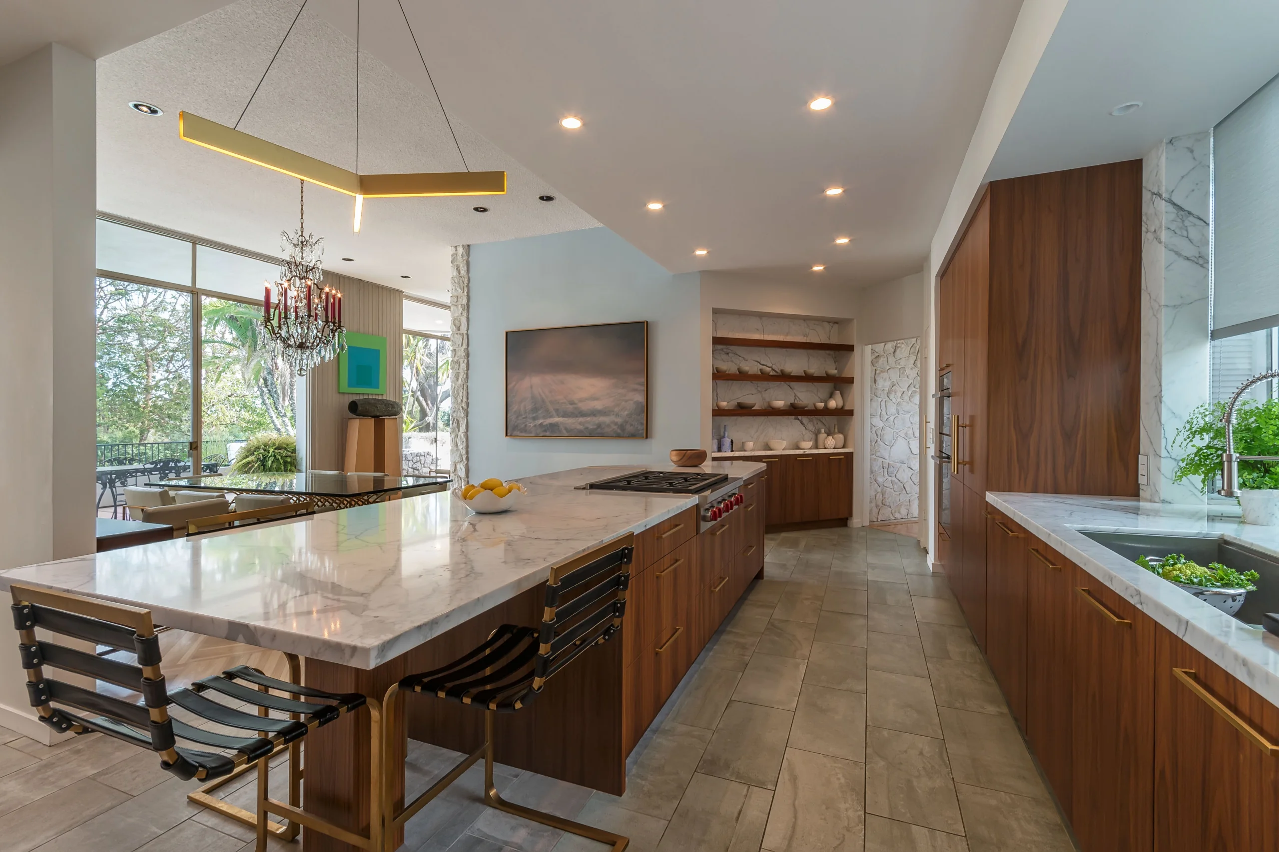 Modern kitchen with custom cabinetry featuring sleek wooden finishes and marble countertops, integrated appliances