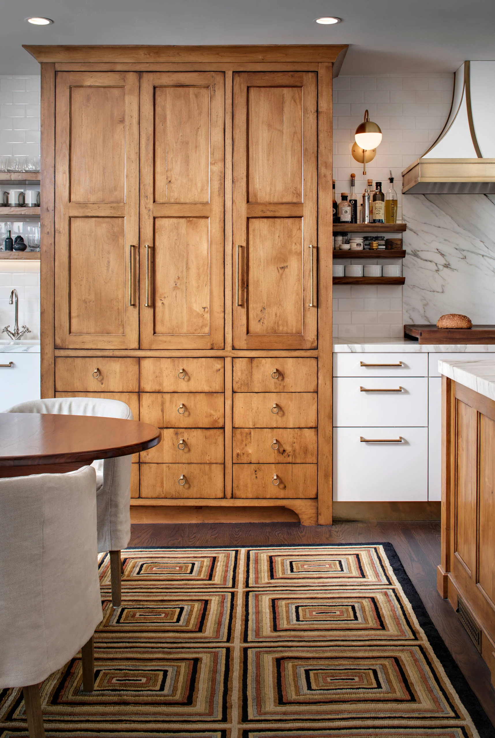 Custom kitchen cabinetry with mixed wood and painted finishes