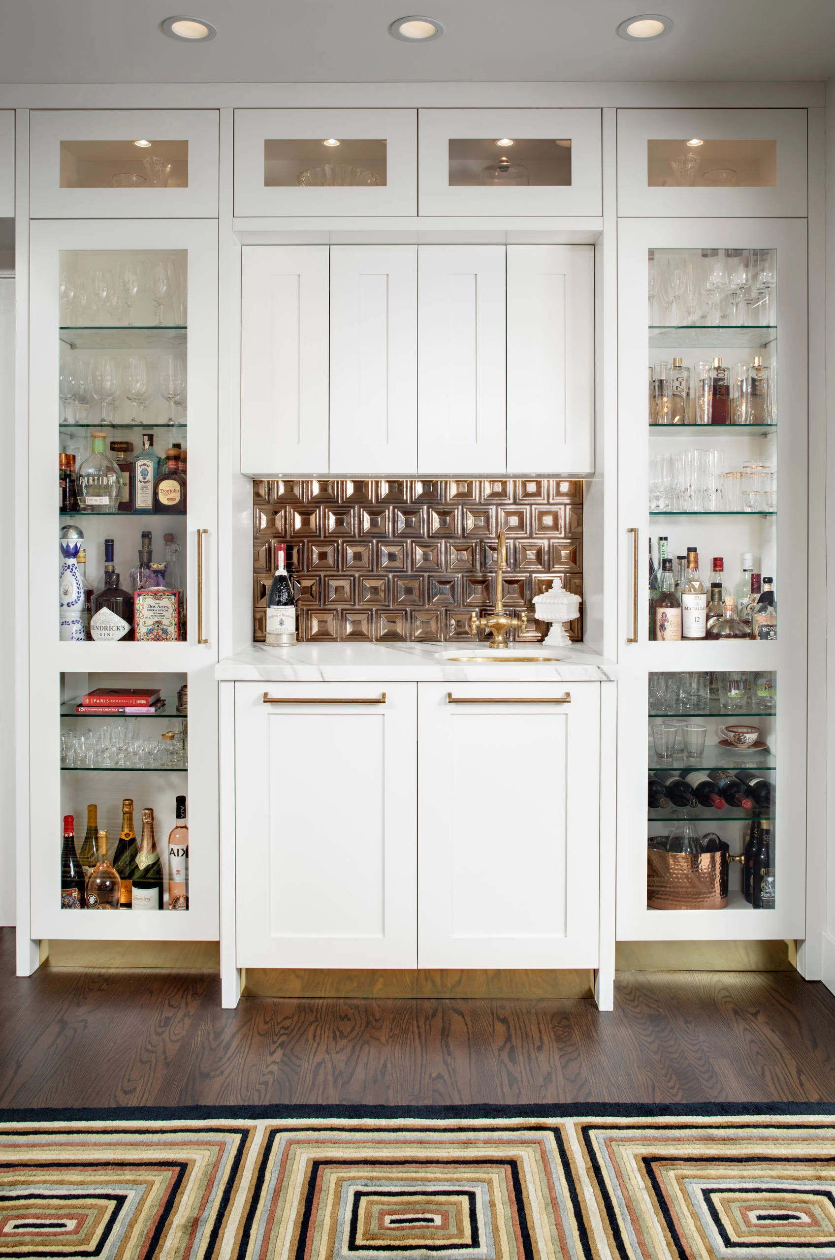Custom white kitchen cabinets with glass-panel doors