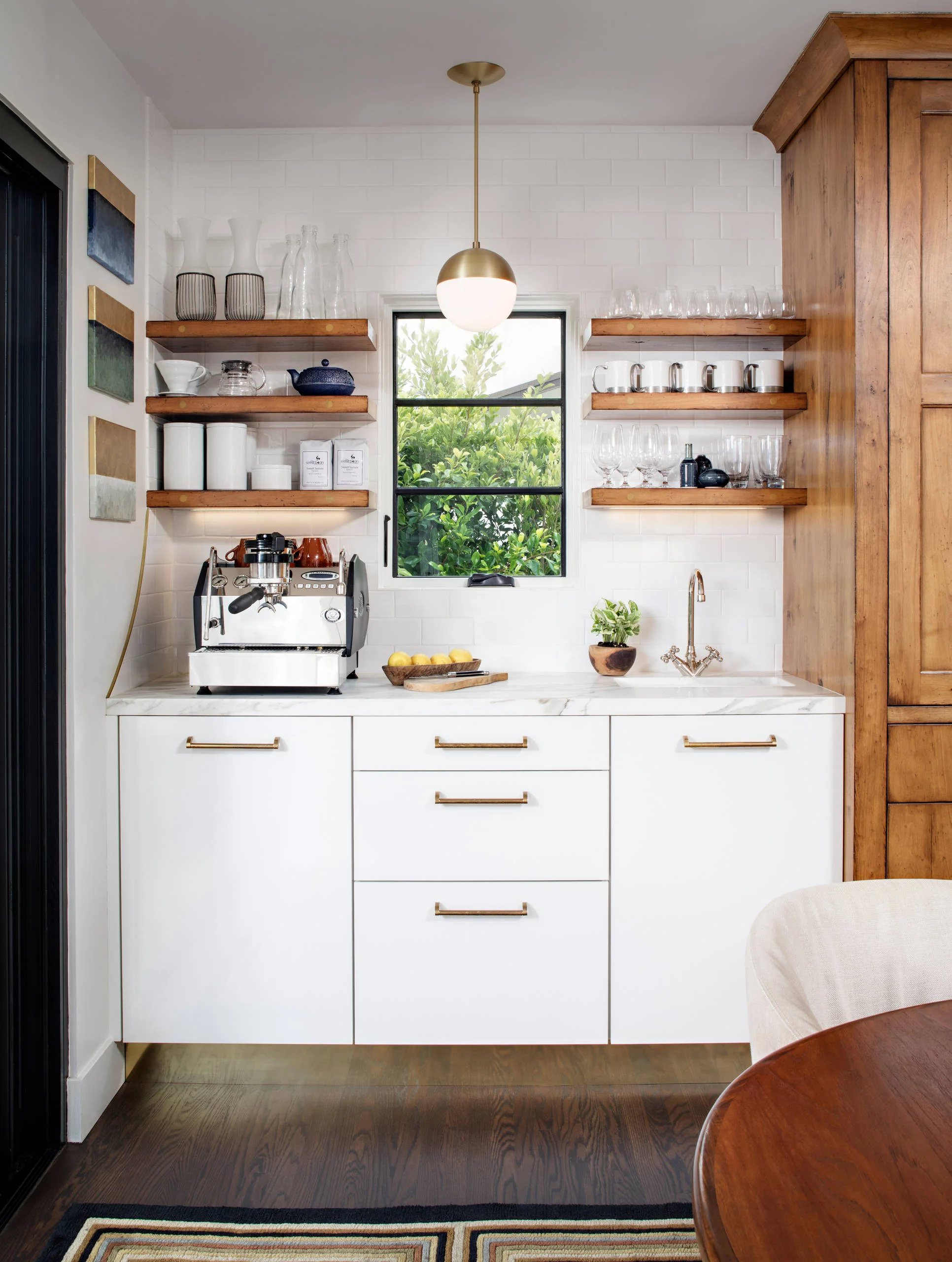 Kitchen corner detail with white custom cabinets and brass hardware