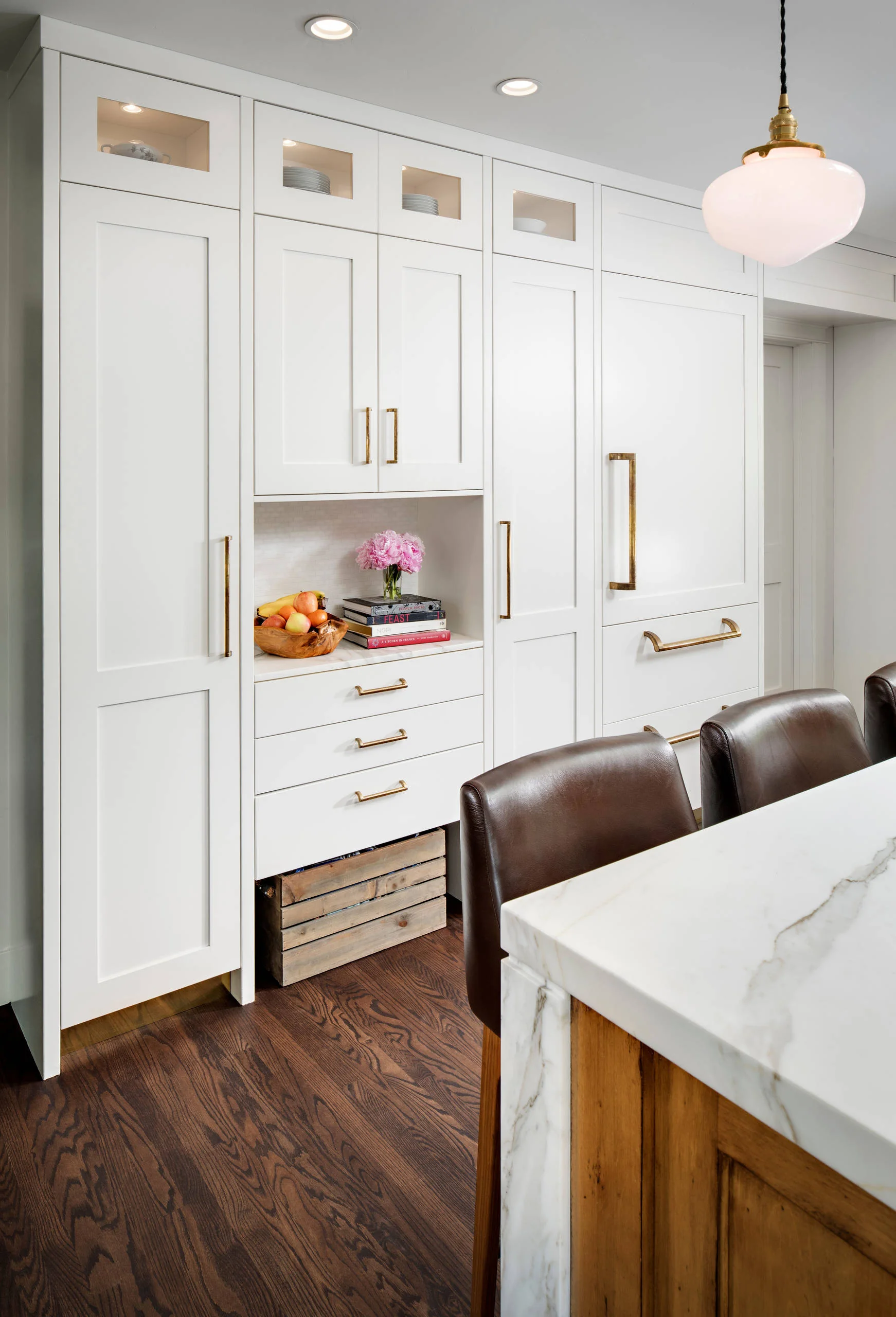 White custom cabinetry with brass hardware in the Mission Hills chef's kitchen