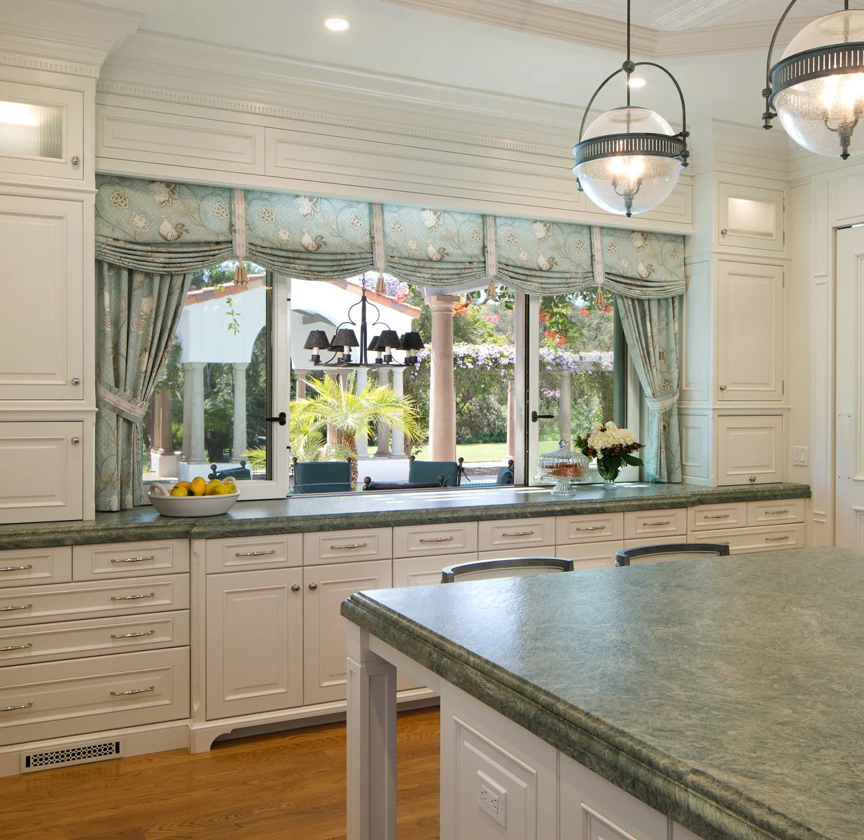 Elegant modern kitchen in San Diego featuring bespoke white cabinets, green marble countertops
