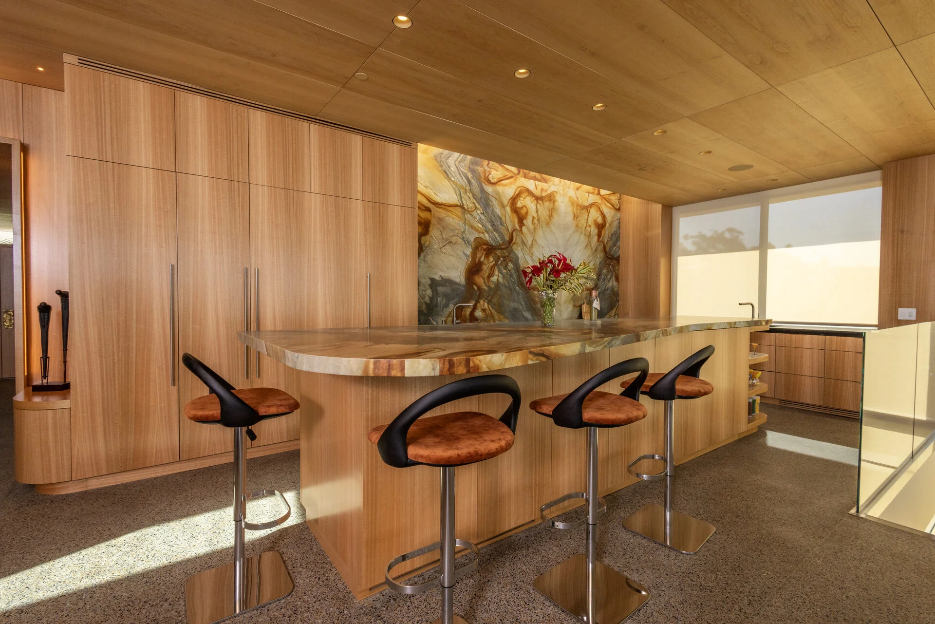 Custom eucalyptus veneer bar and curved cabinetry &mdash; San Diego custom cabinetry by Inplace Studio