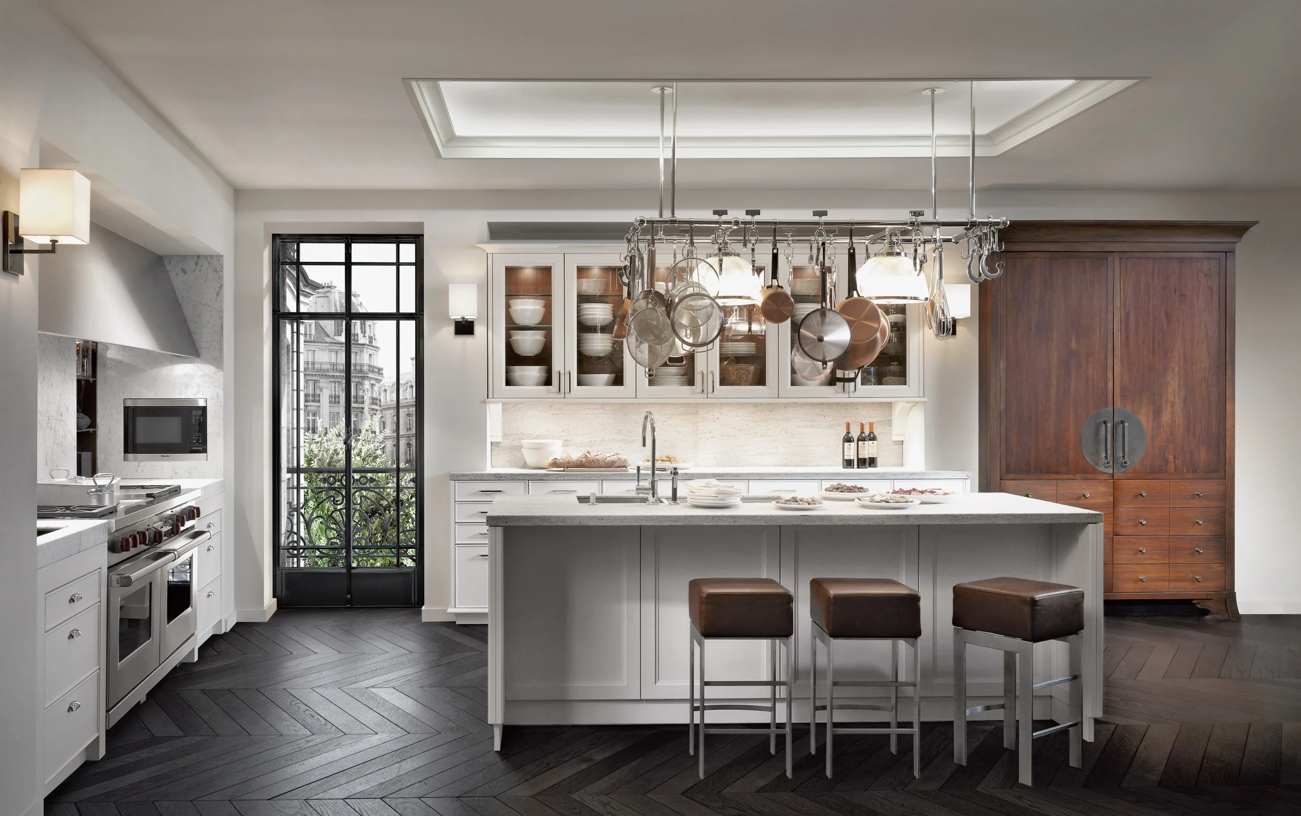 Modern kitchen with elegant custom cabinetry, featuring white cabinets, marble countertops